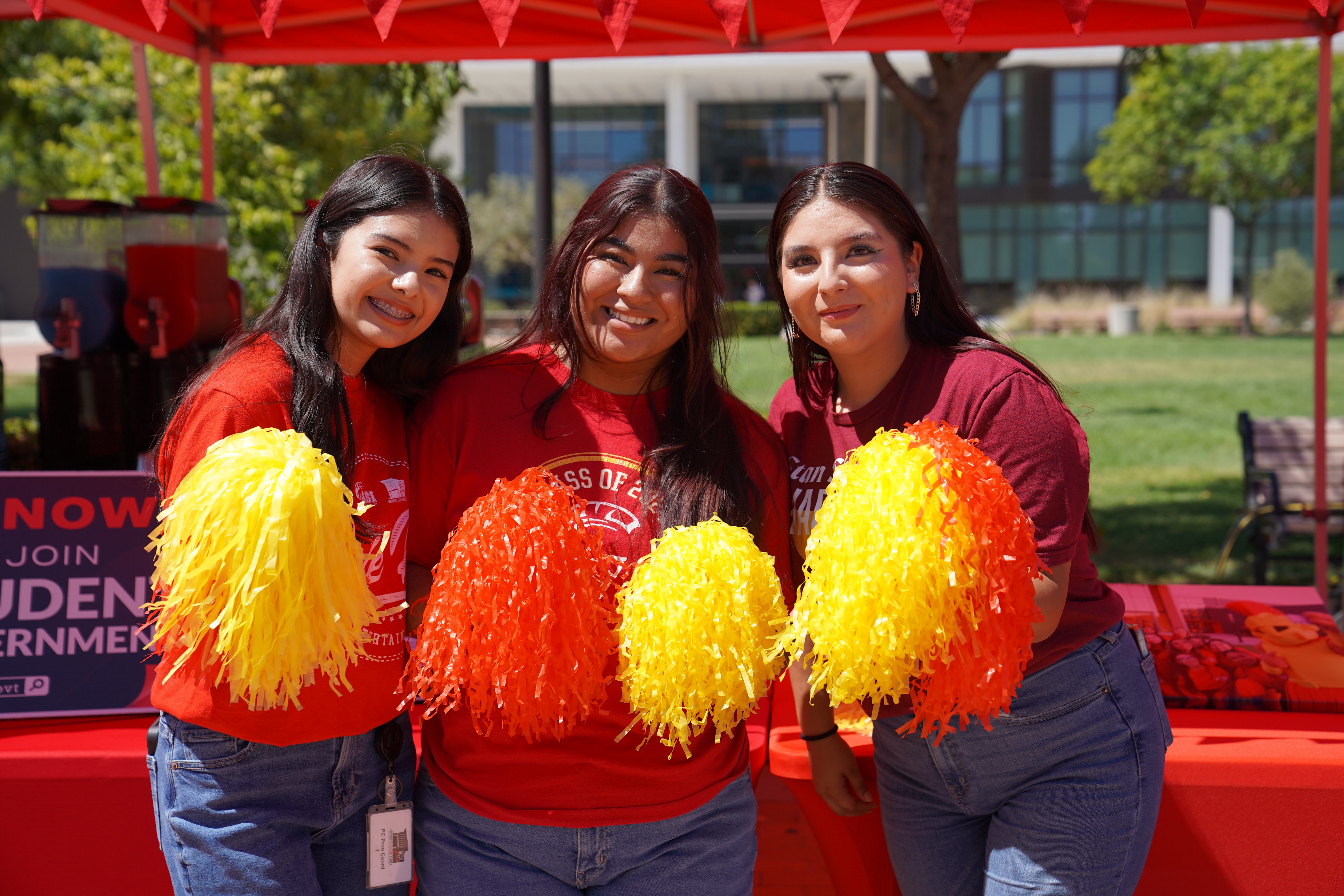 Three students posed with pomp poms