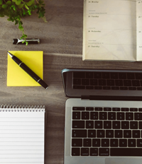 Desk with writing pad, laptop