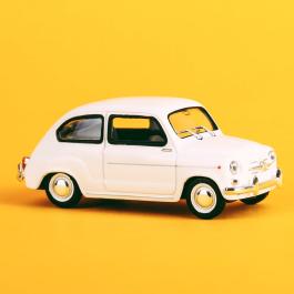 Car in front of a yellow background