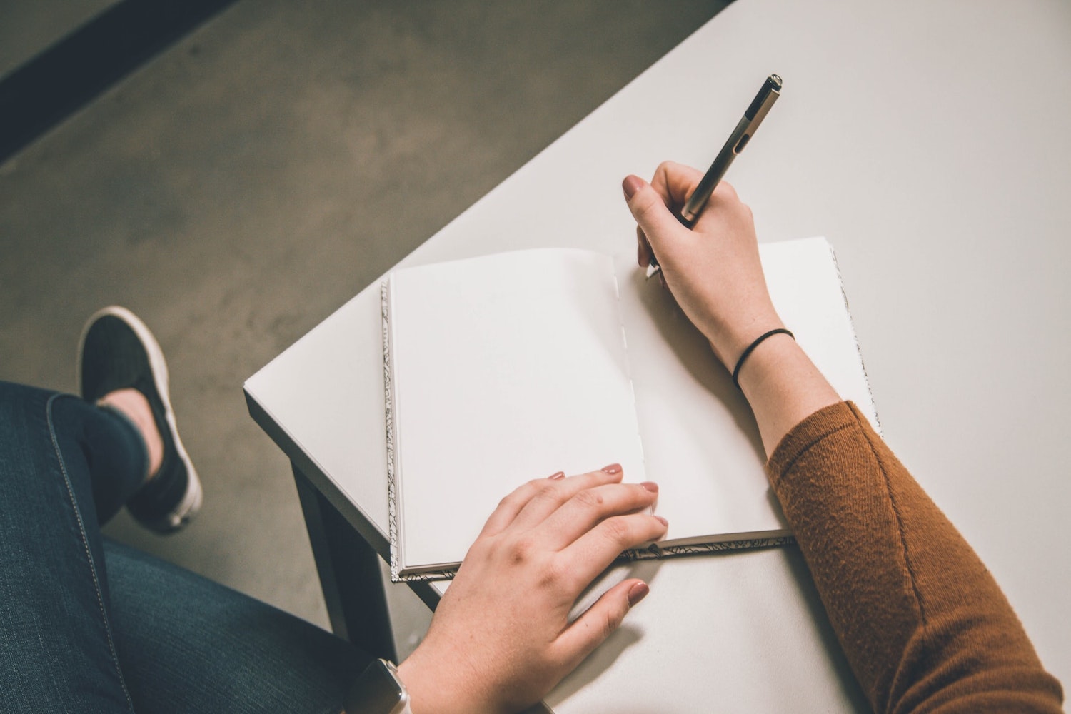 student writing in notebook