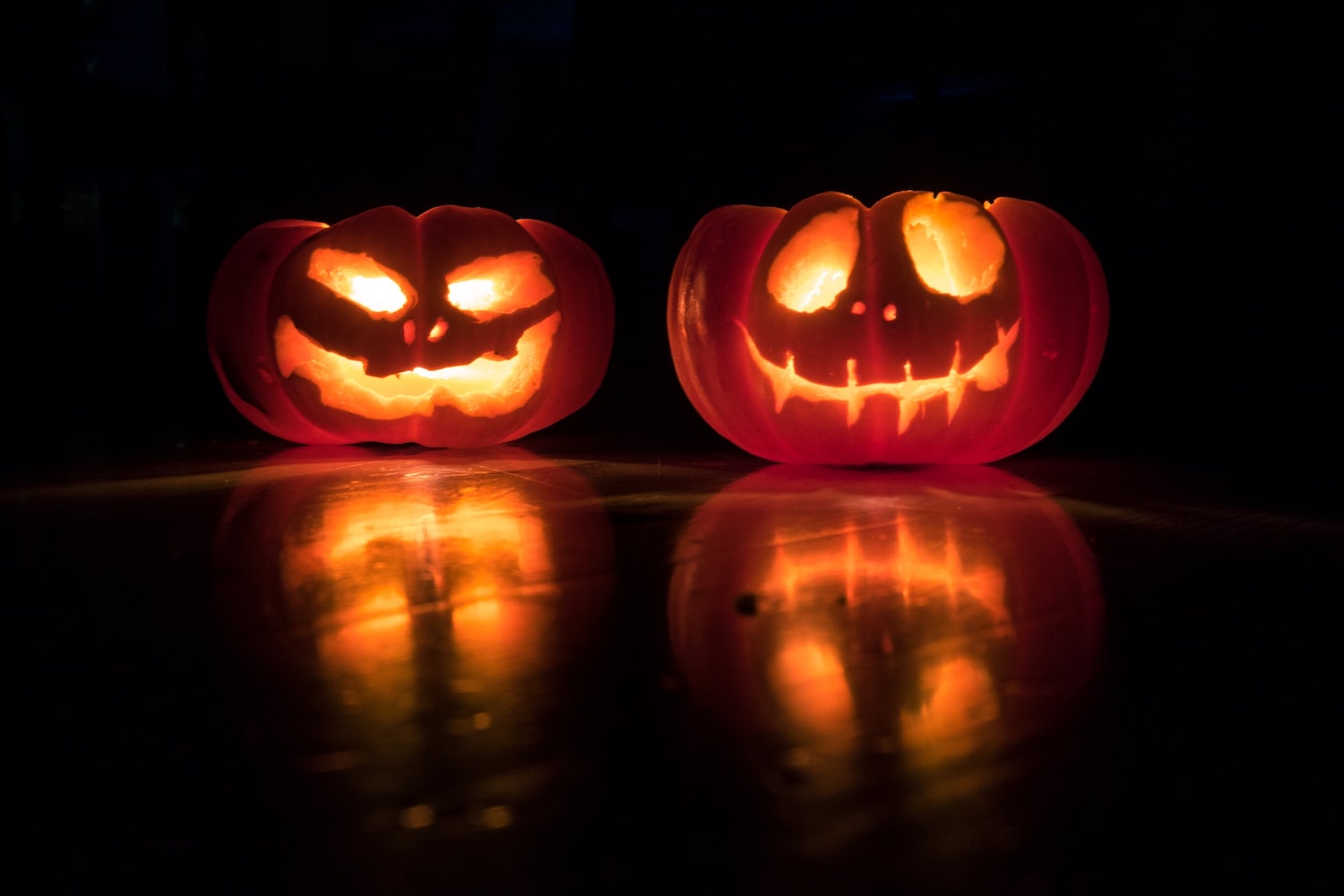 Two lit up pumpkins. 