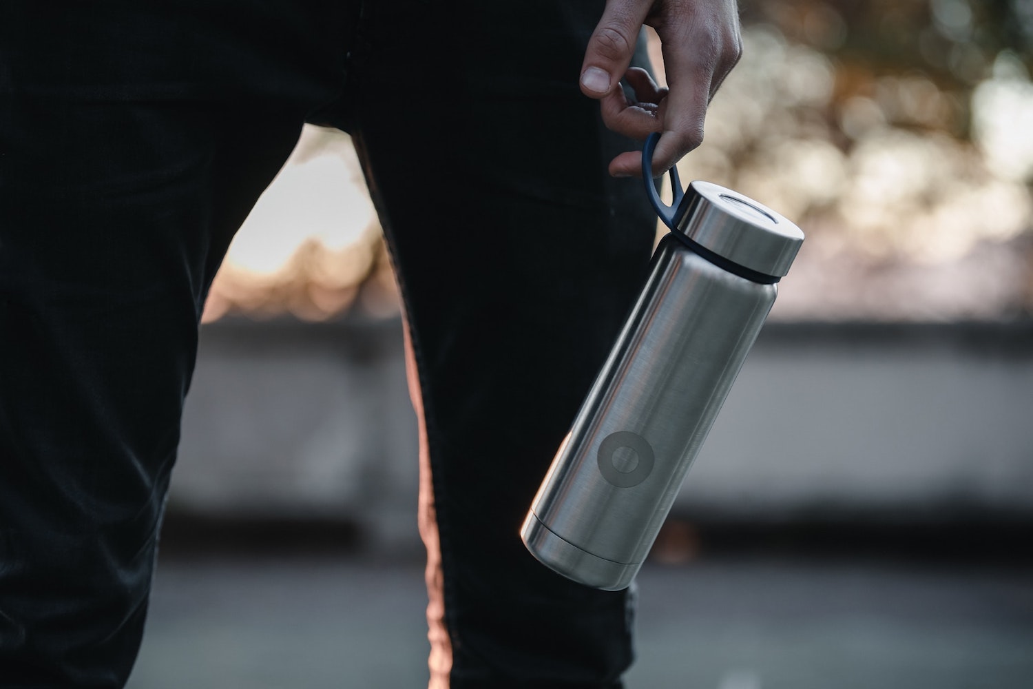 Man holding a hydro flask. 