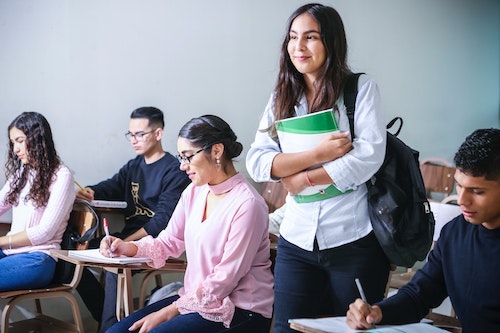 Students taking notes in class.