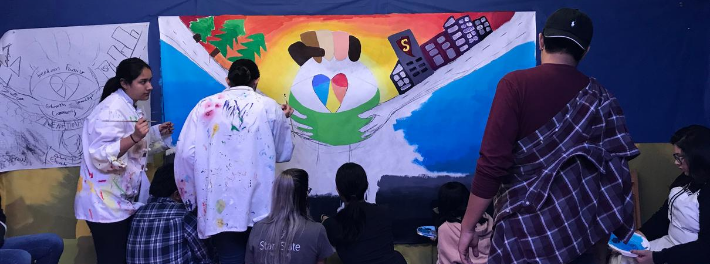 Stan State students creating Social Justice painting.