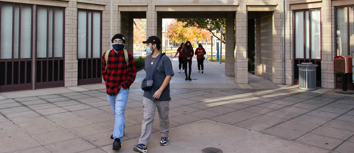 Students walking outdoors on campus.