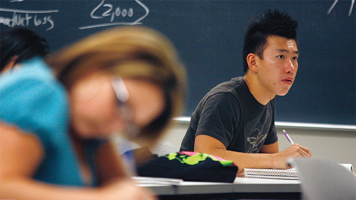 Students taking notes in class.