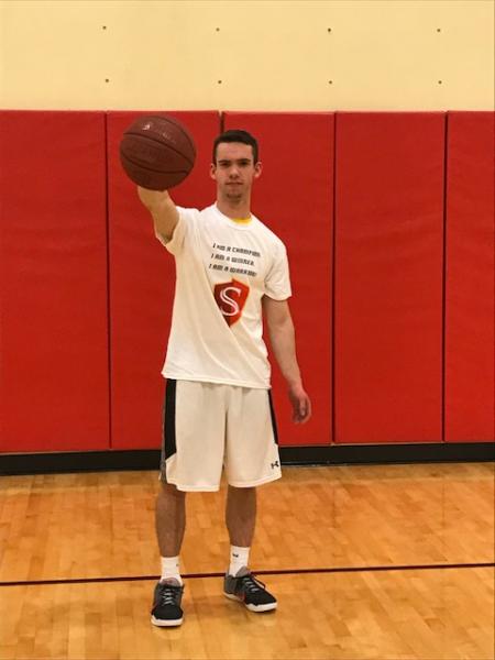 Student holding basketball.