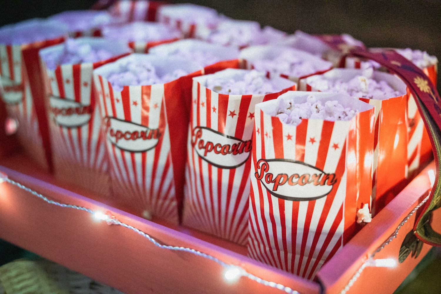 White and red popcorn bags filled with popcorn.