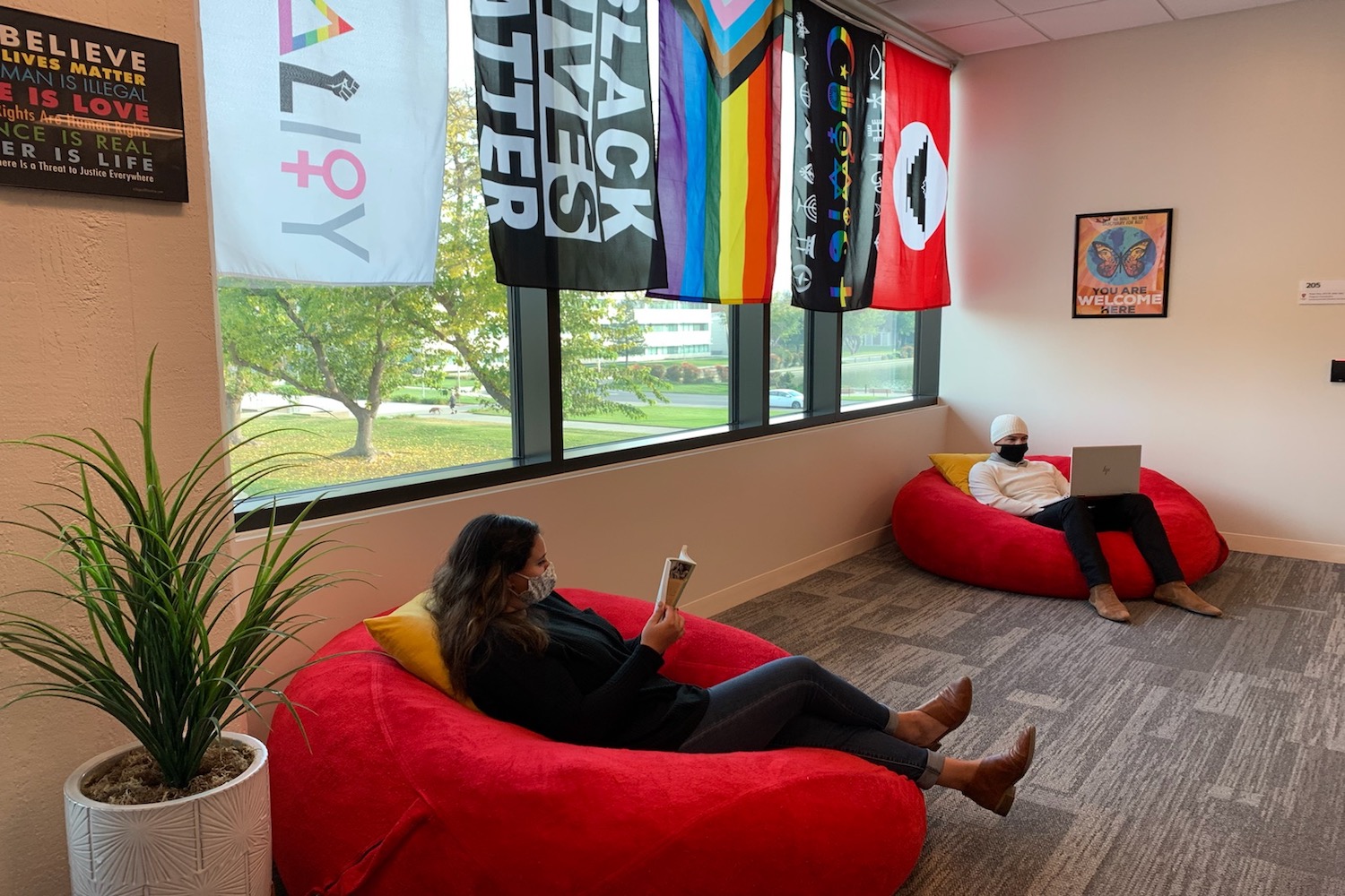 Two students sitting on bean bag chairs.