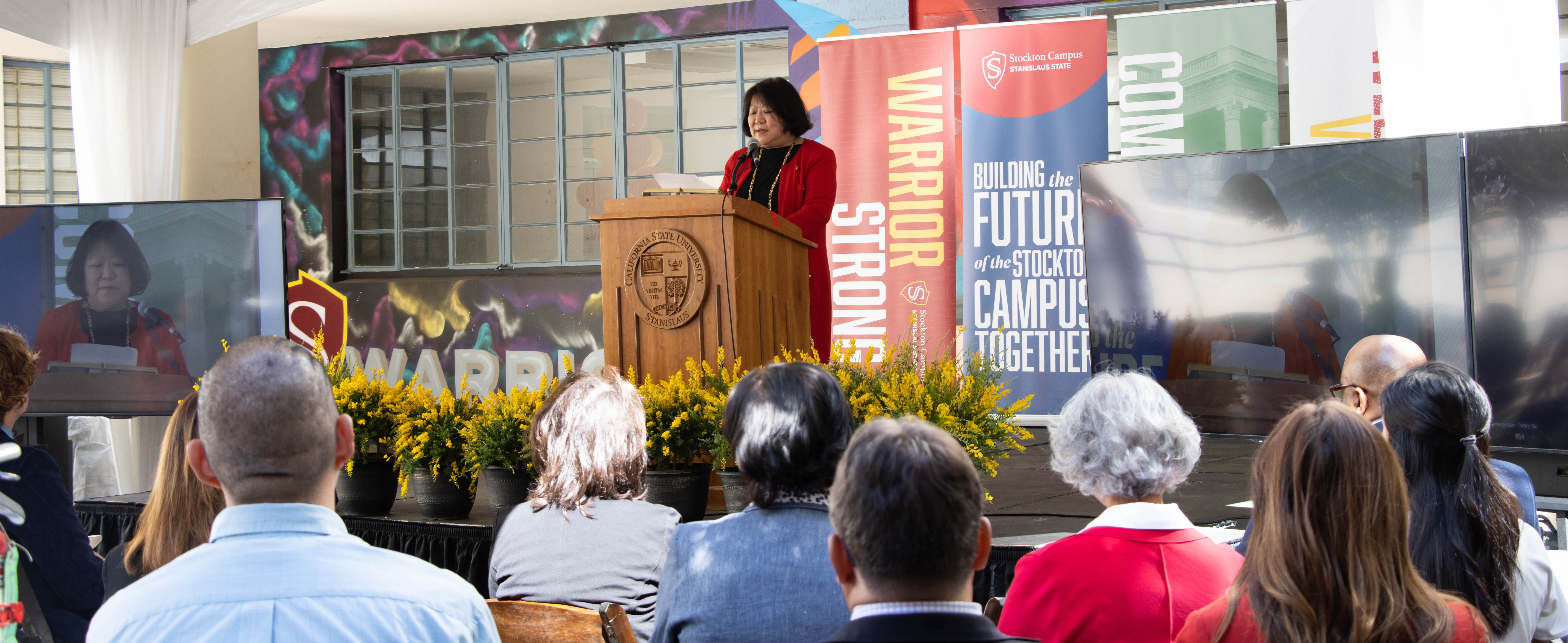 President Ellen Junn speaking to an audience.