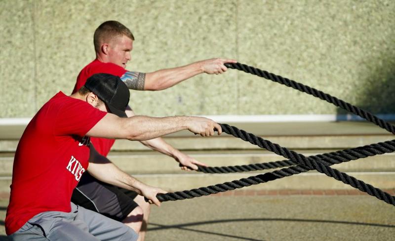 People exercising using ropes