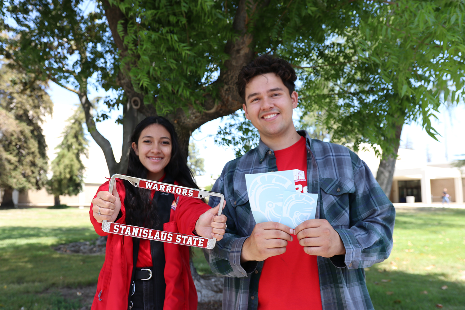 students holding license plate frame and decals