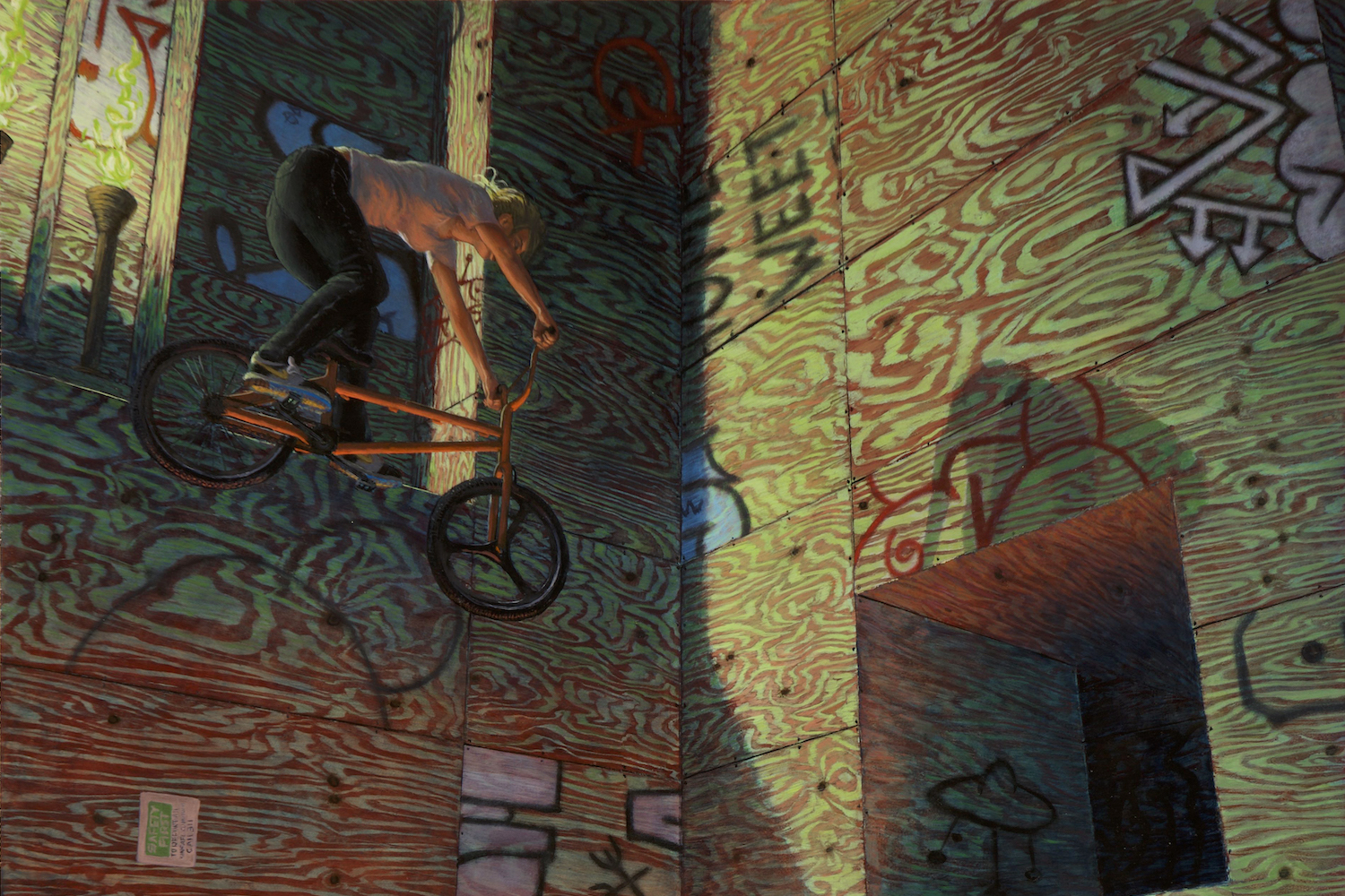 Man riding a bike mid-air, walls are covered in writing