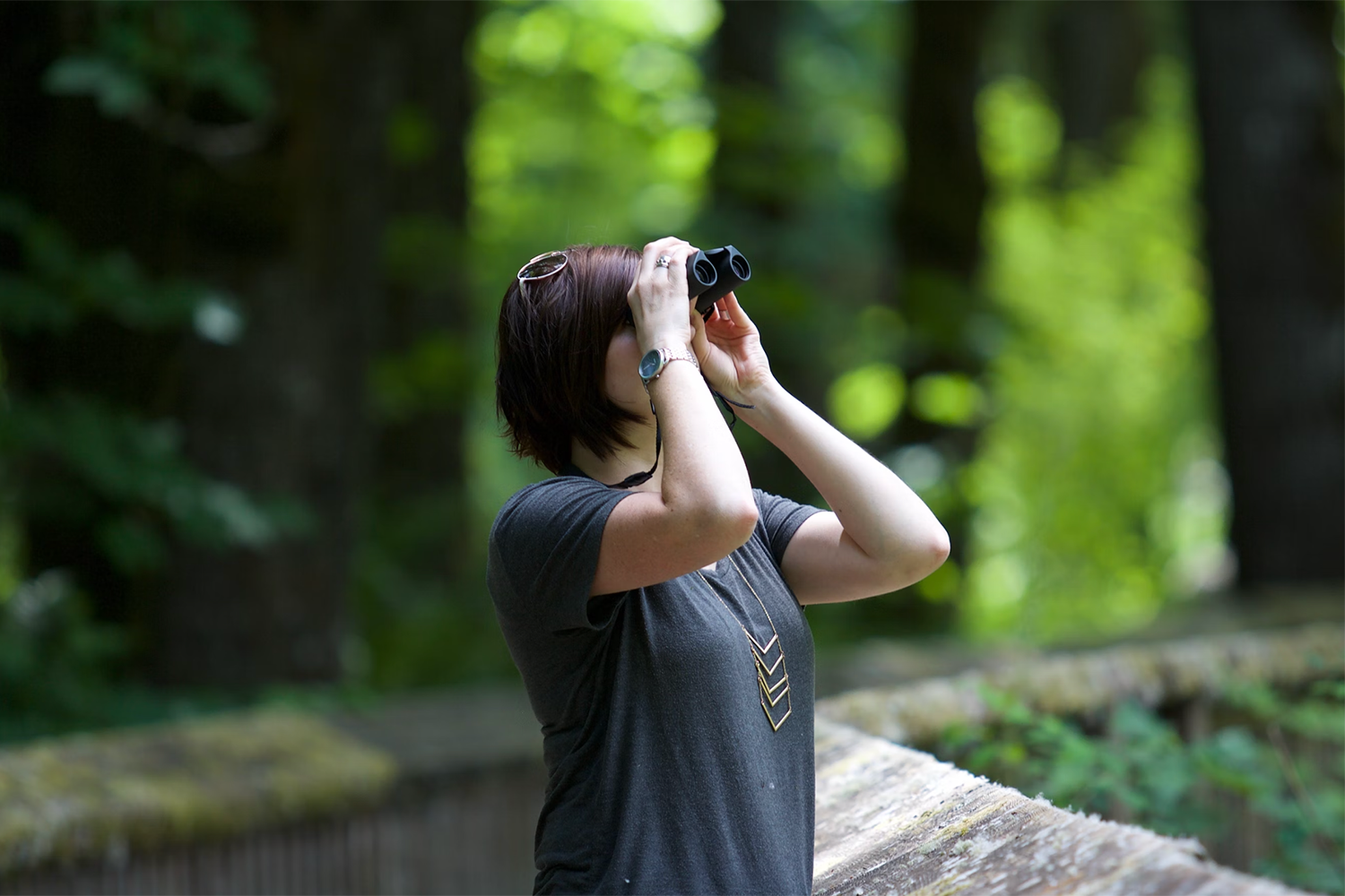 student looking through binoculars