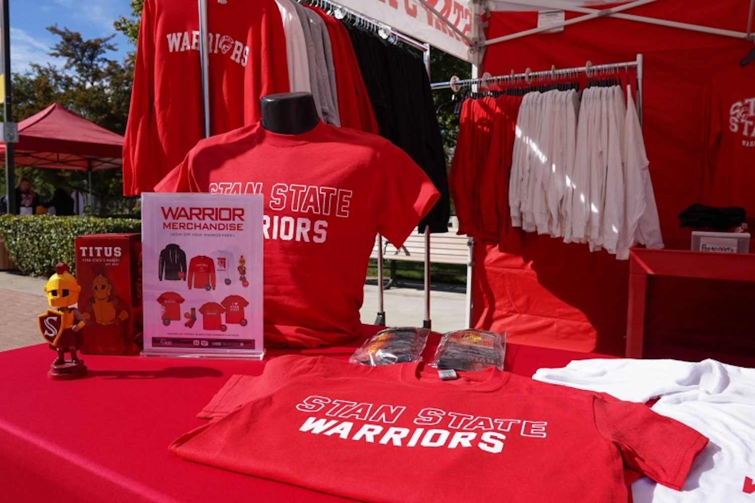 Table with shirts on display reading "Stan State Warriors"