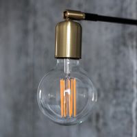 Lamp with an exposed light bulb