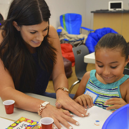 A teacher and a student work on arts and crafts