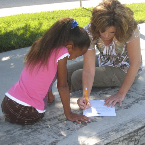 A student and a student coach working together