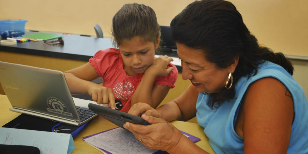 Teacher and student working on a tablet