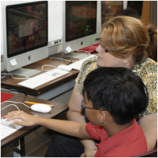 Student and a teacher at a computer