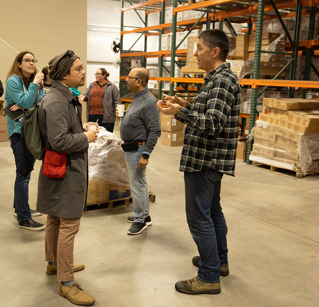 Marketing students visit a warehouse for a class project.