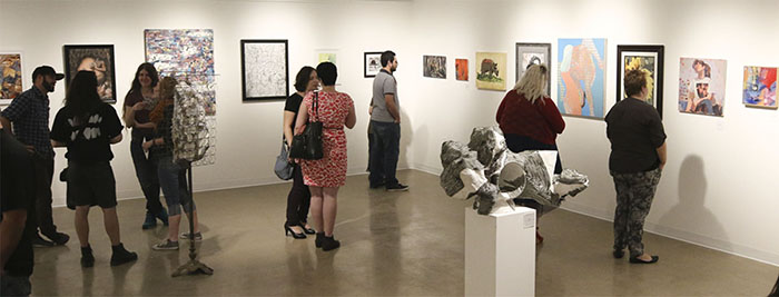 ssas_galleryinterior01.jpg Group of people observing paintings