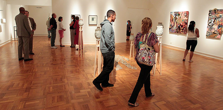 People walking around the gallery