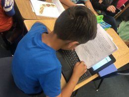 Kid reading at desk