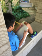 Child writing outside