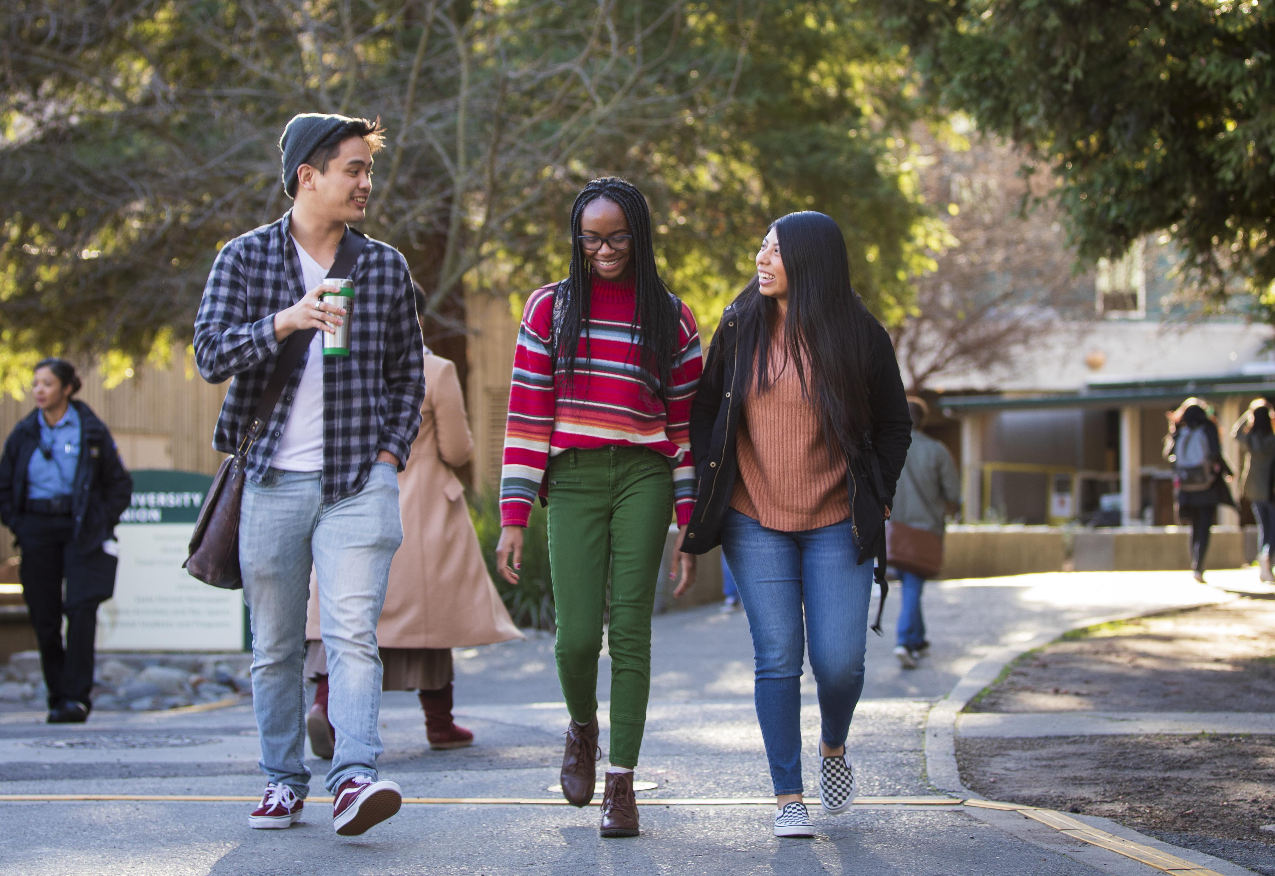 Group of three Students Walking.