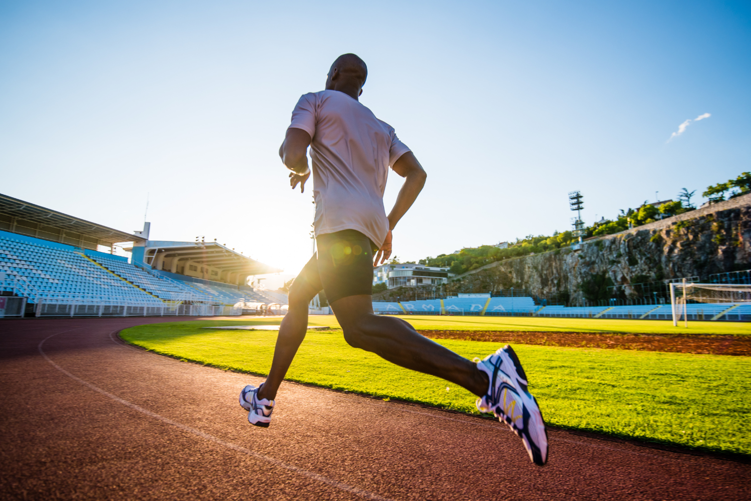a man running on a sports track.