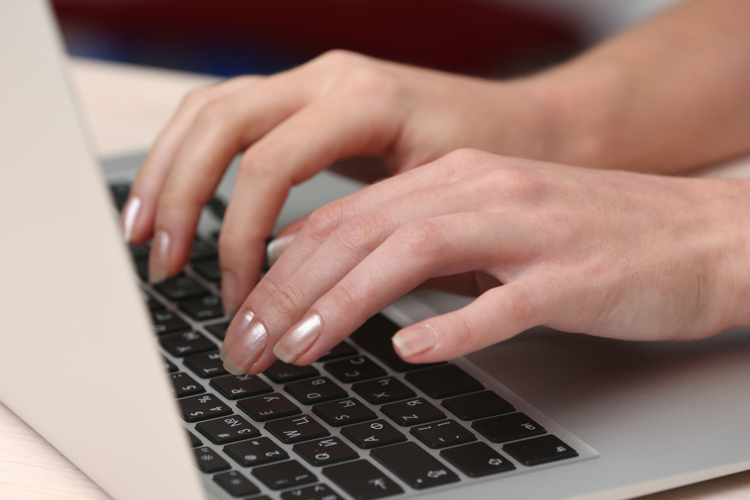 User resting hands on laptop.