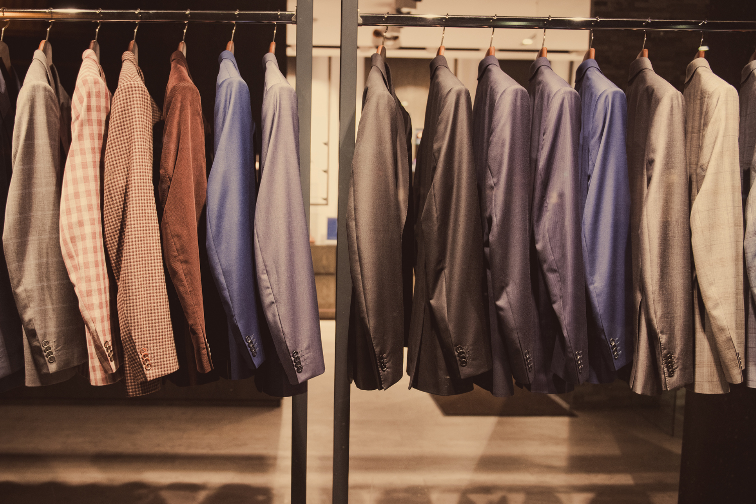 business dress attire hanging from a clothing rack 