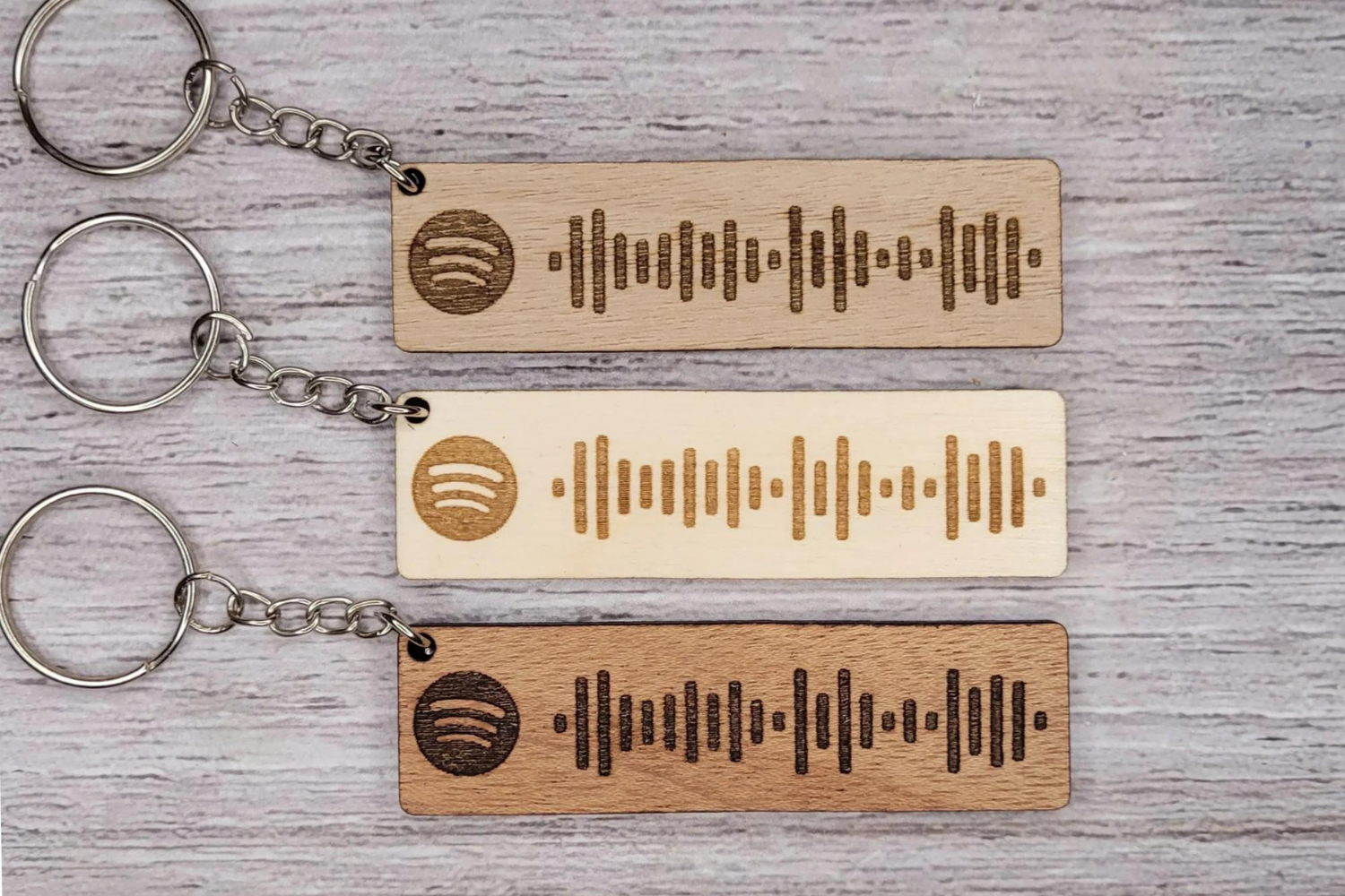 3 keychains with laser engraved Spotify scannable links
