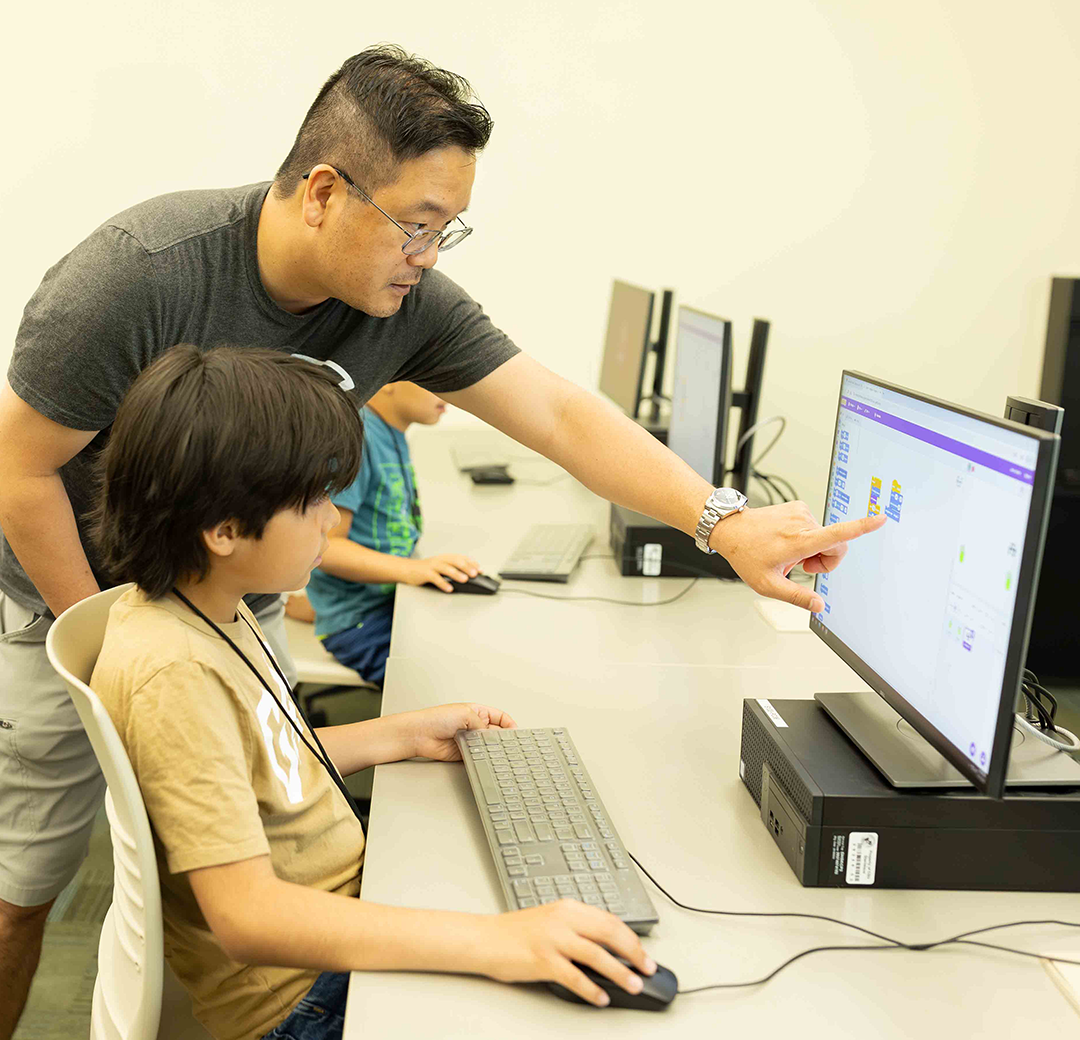 Kyu Han Koh and an elementary school student at summer coding camp.