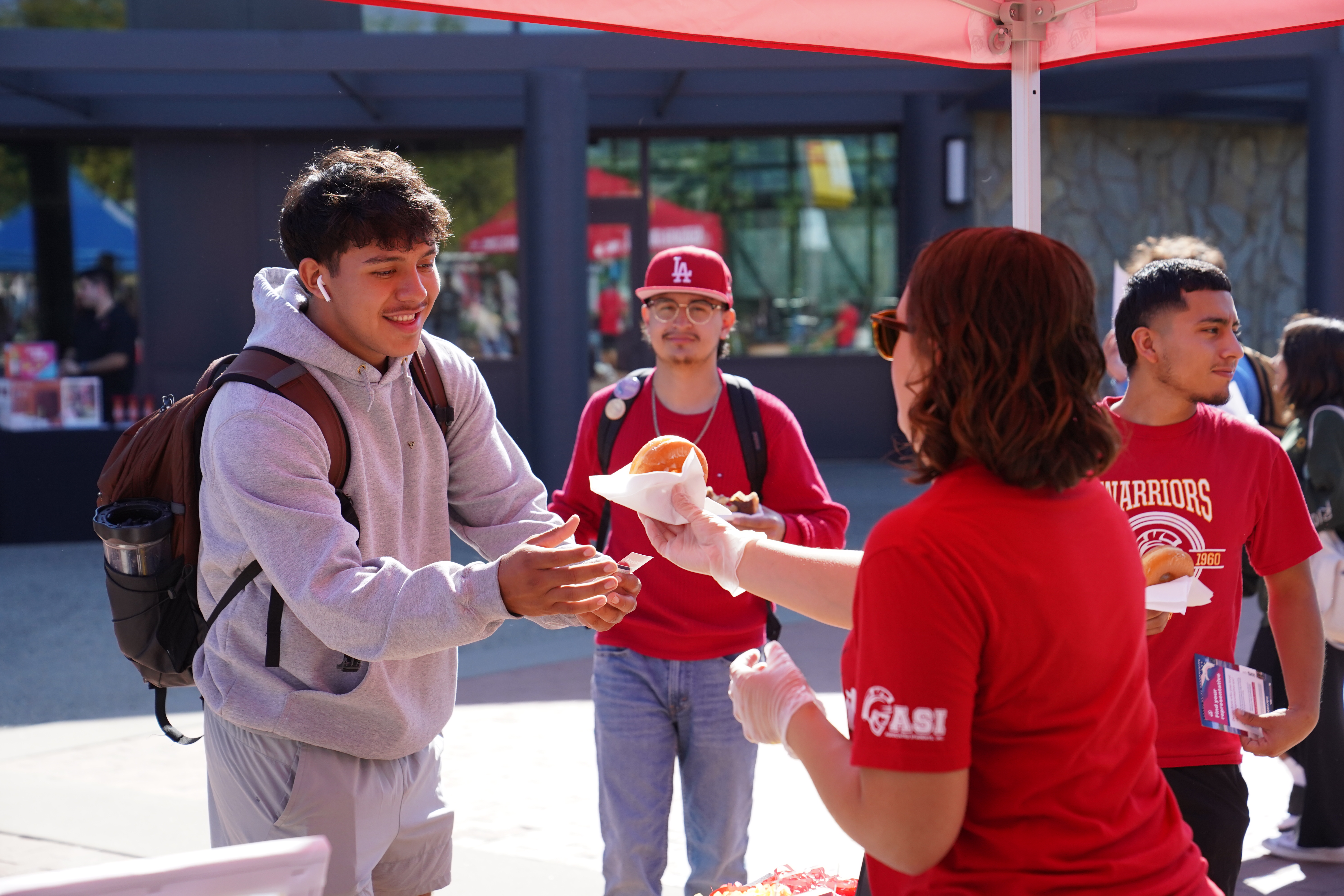 ASI voter registration booth handing out doughnuts.