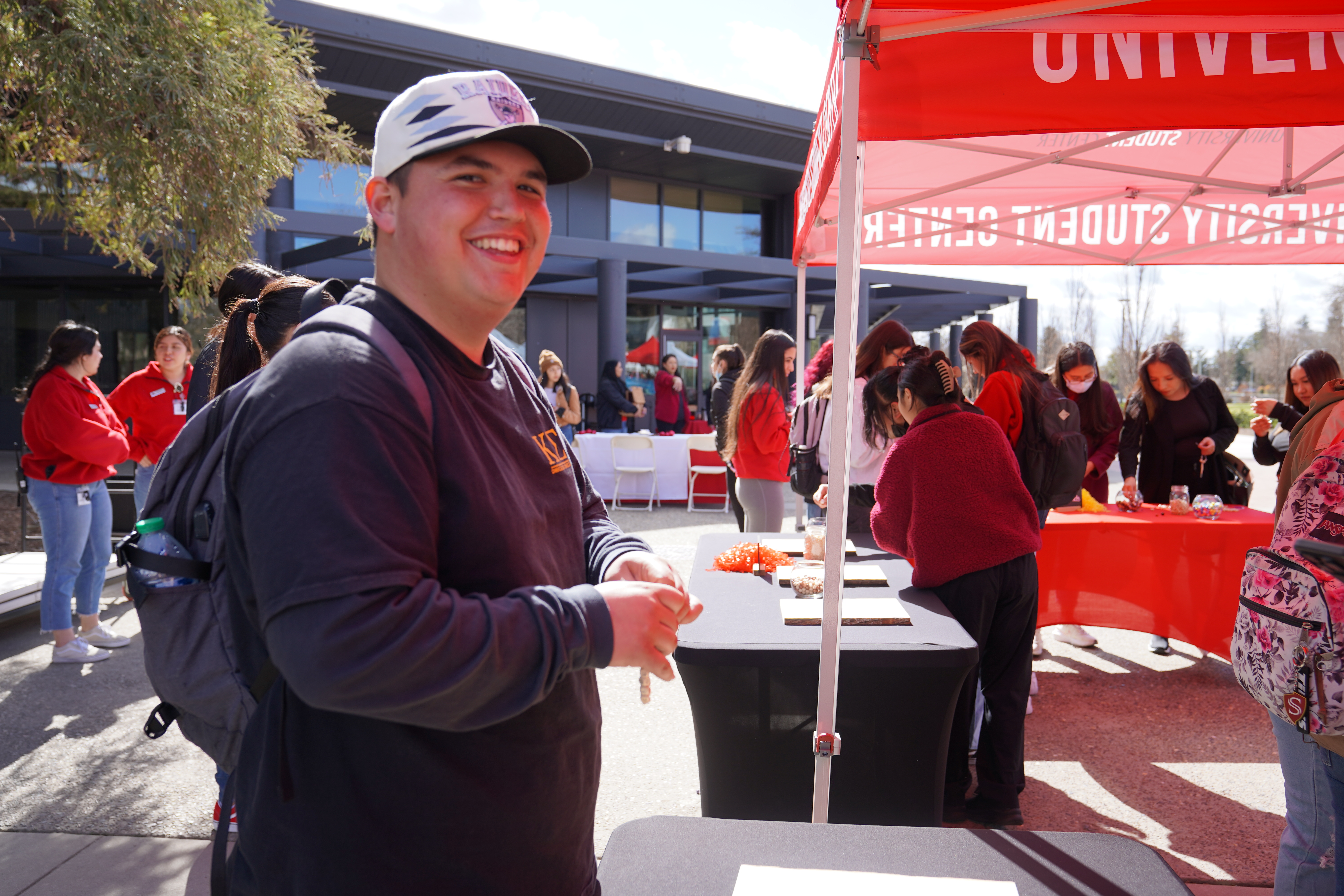 Student wearing gray hat smiling