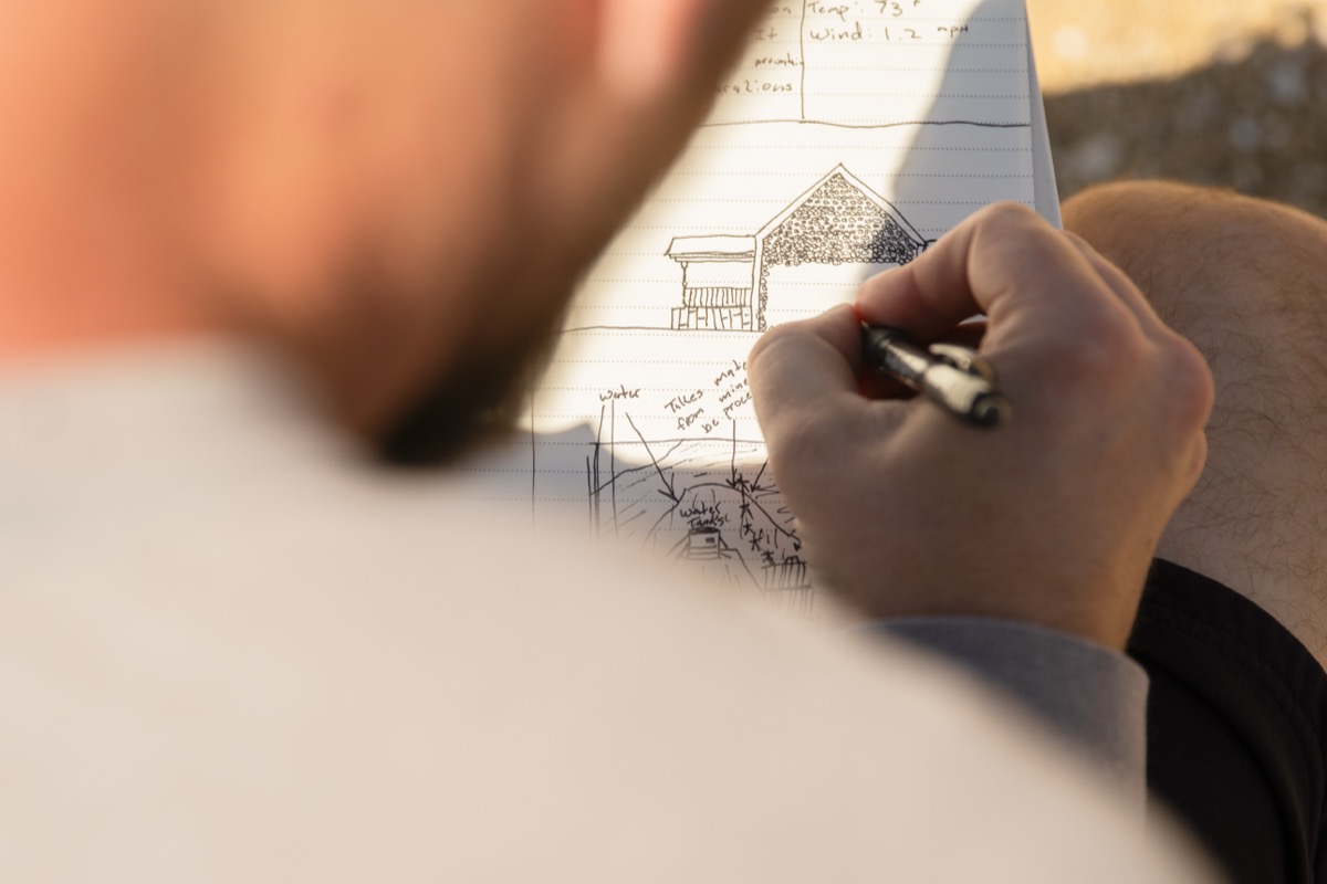 student sketching in field journal