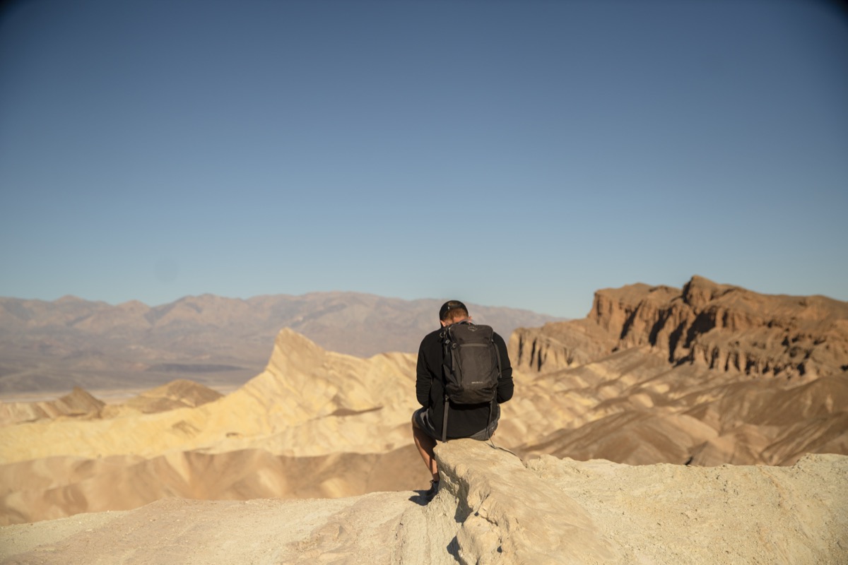 Student sketching with Zabriskie Point and Manly Peak in the distance