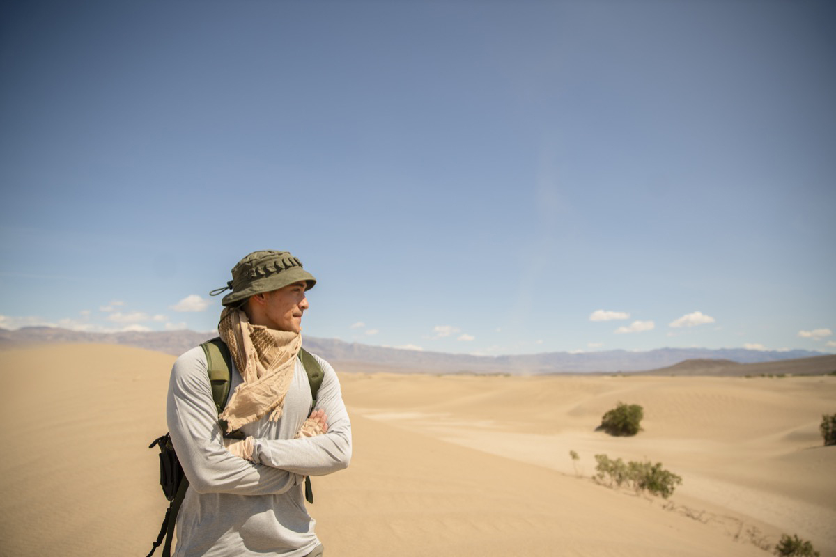 student poses for photo in the dunes