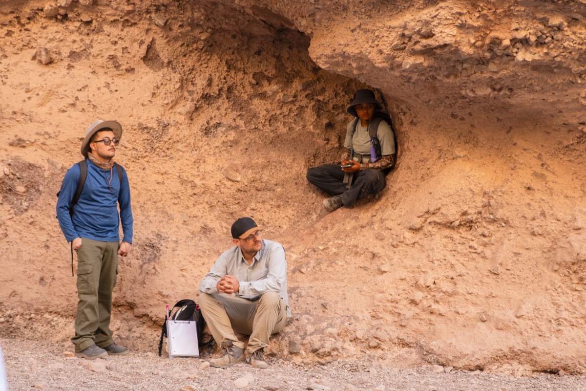 students taking a break in Natural Bridge Canyon
