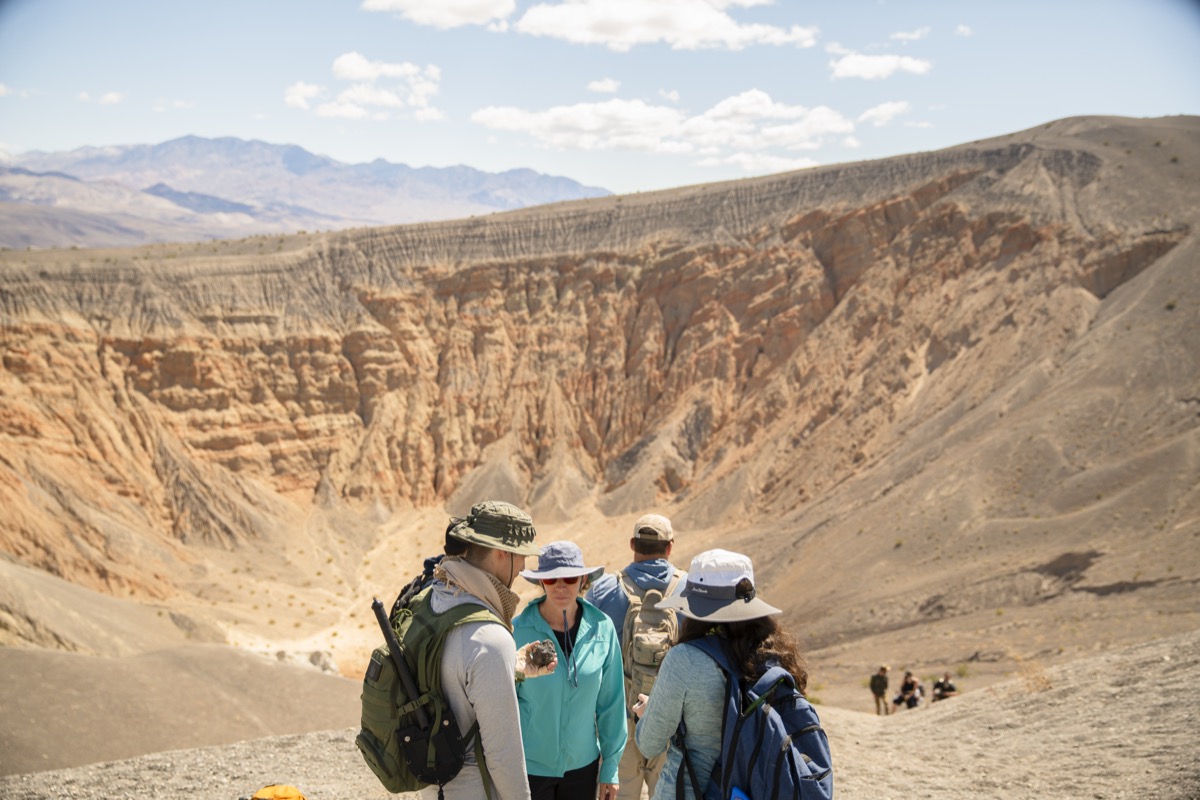 looking at rocks at the rim of Ubehebe Crater