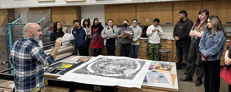 Faculty teaching students the art of printmaking.