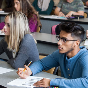 A group of students taking notes during a biology lecture.