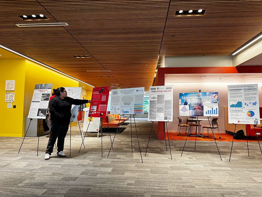 Student presenting their poster