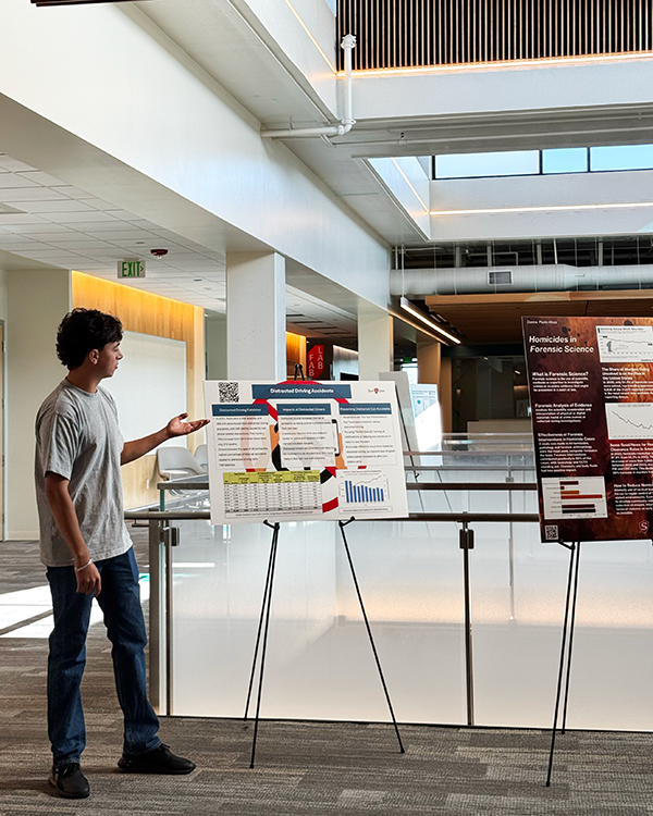 Student presenting their poster