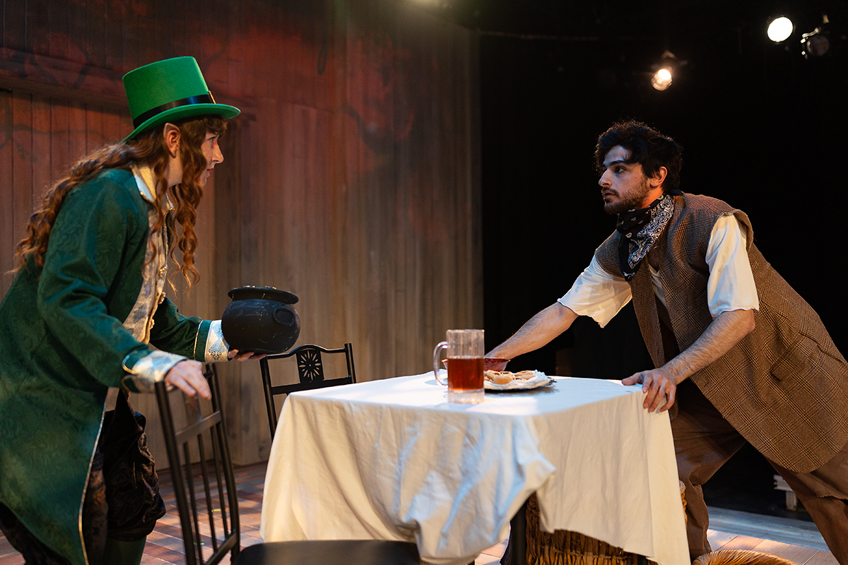 Theatre students perform on stage in costumes.