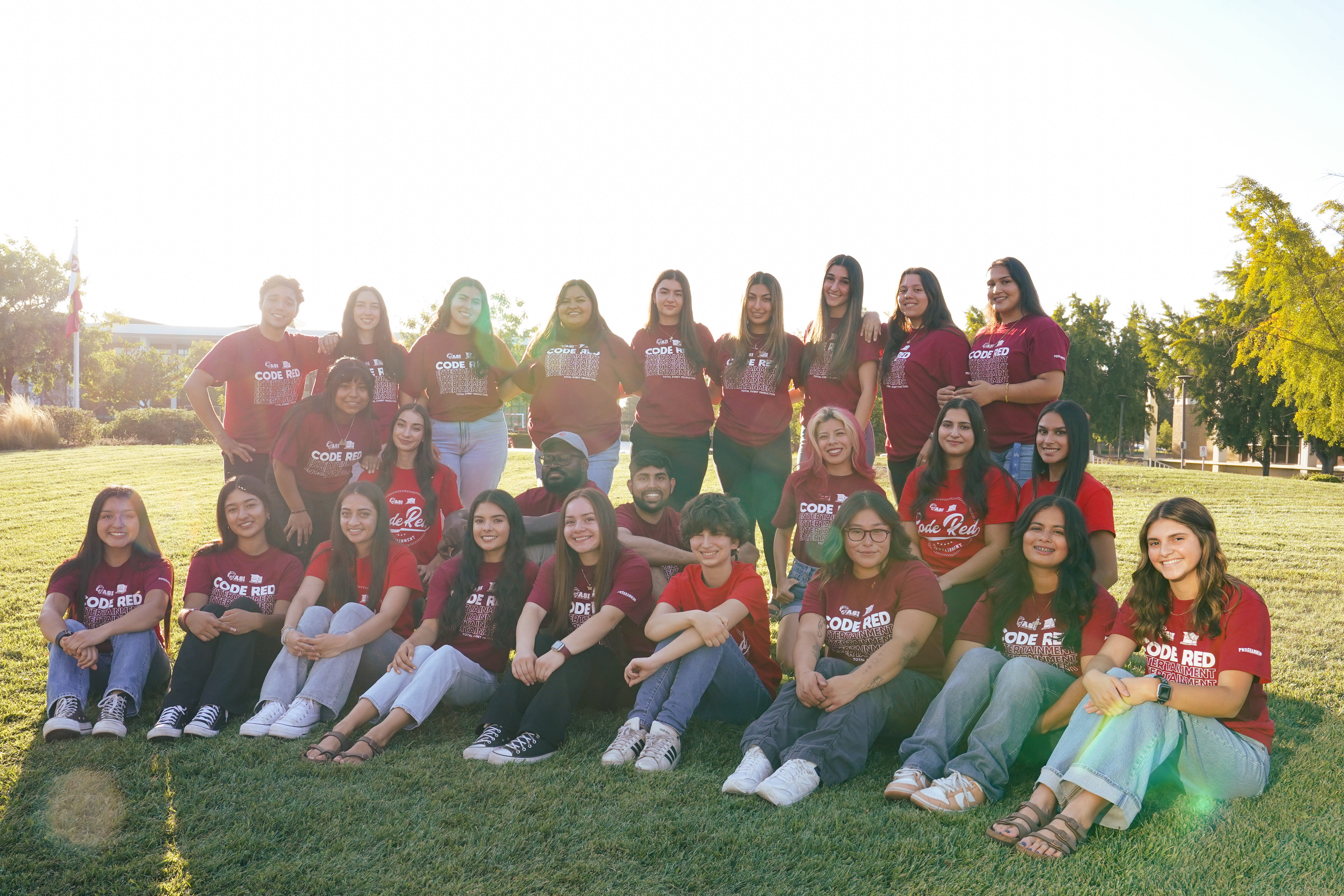 Code Red Entertainment students sitting on a field.