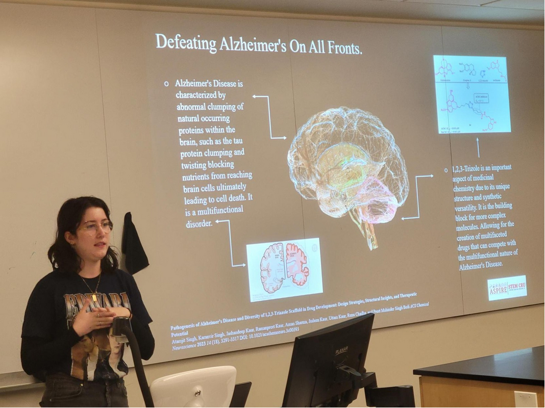 Student presenting their SLAM presentation on defeating Alzheimers disease