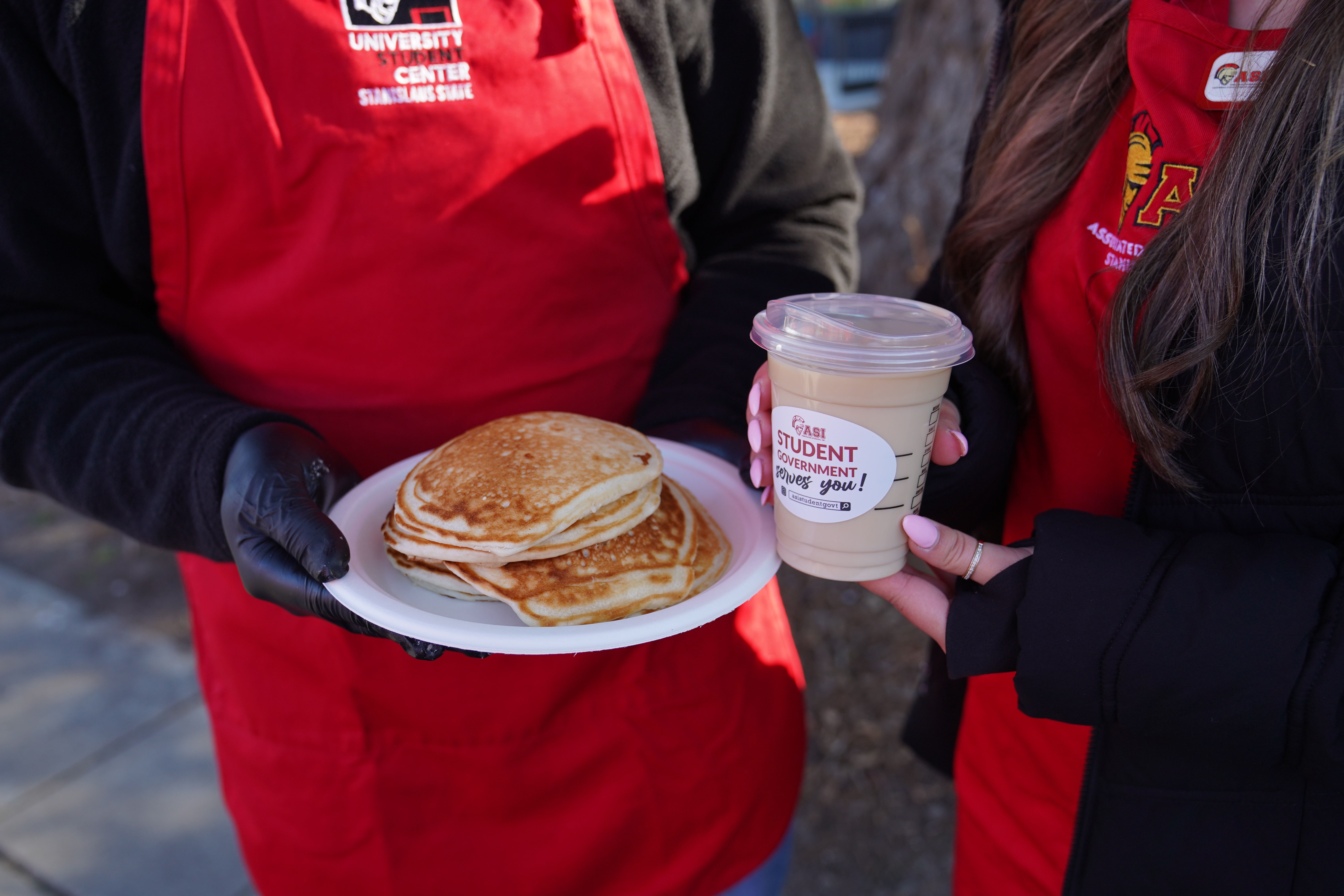 Students holding coffee and Pancakes